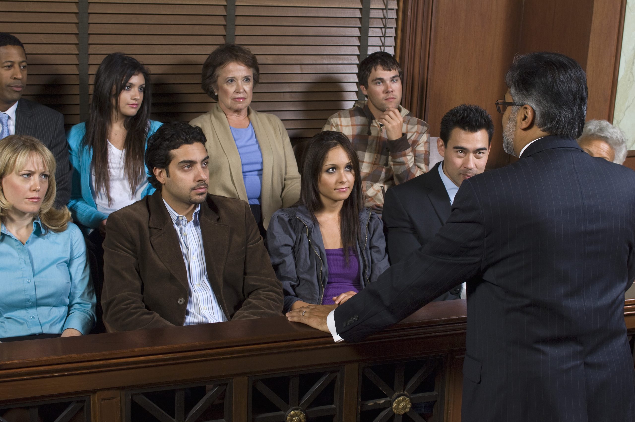 Attorney addressing jury in courthouse