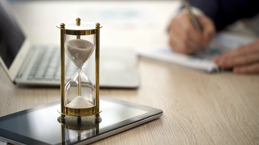 Golden hourglass sitting on a table