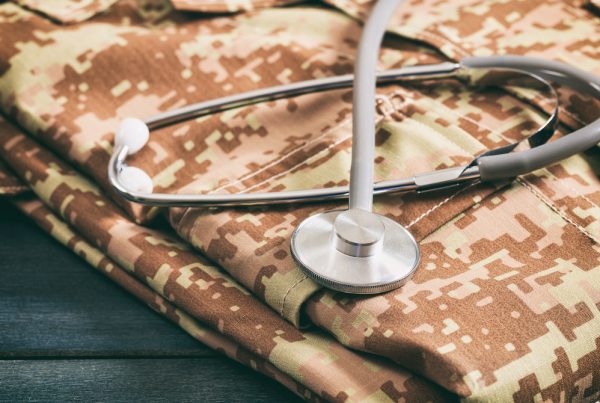Folded military uniform with stethoscope