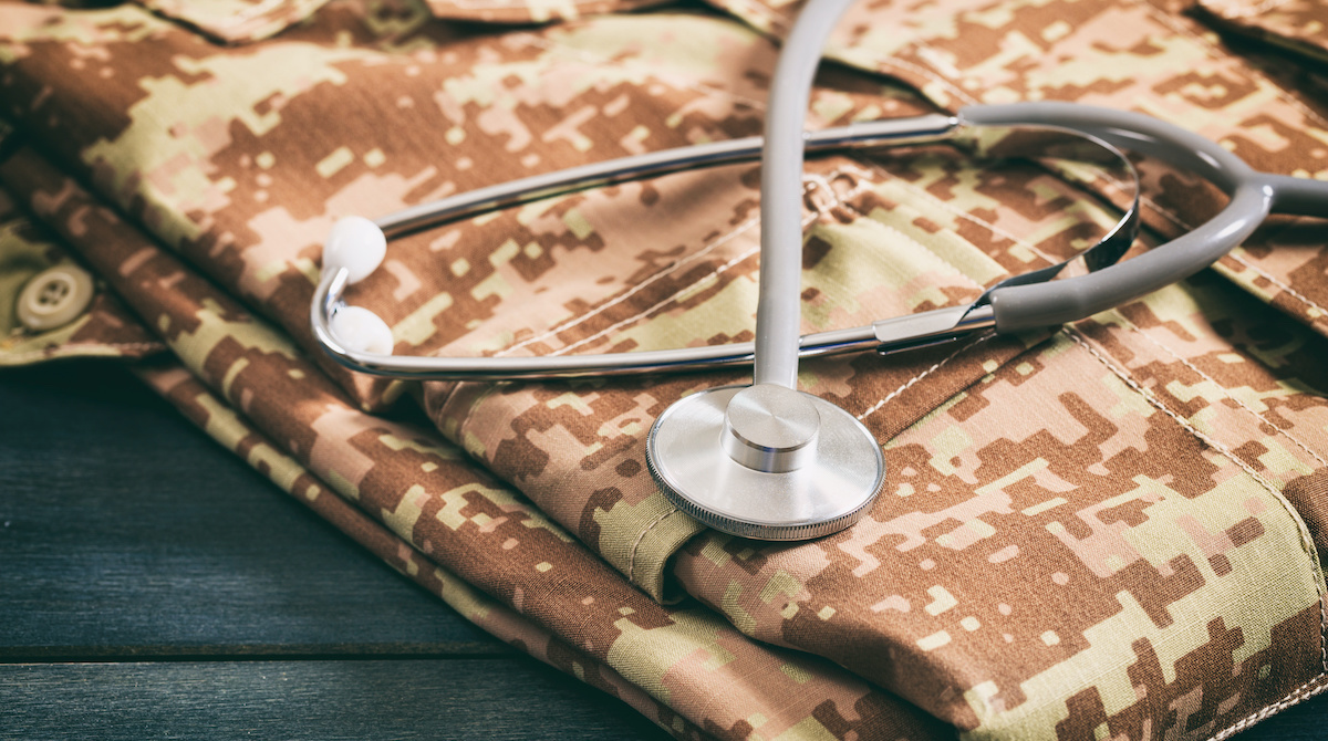 Folded military uniform with stethoscope