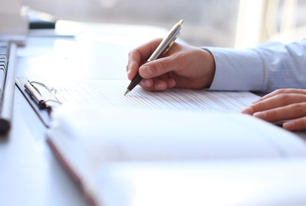 Man attempting to organize his own personal injury case, taking notes