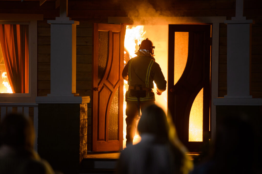 fireman entering a burning home.