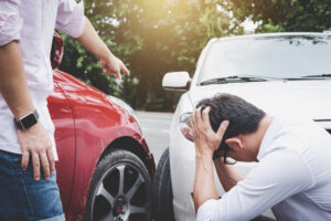 Two drivers man arguing after a car traffic accident collision, Traffic Accident and insurance concept.