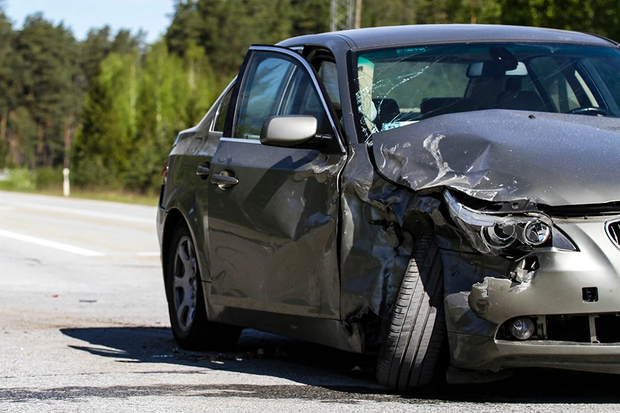 A passenger vehicle with a heavily damaged front passenger side after a car accident.
