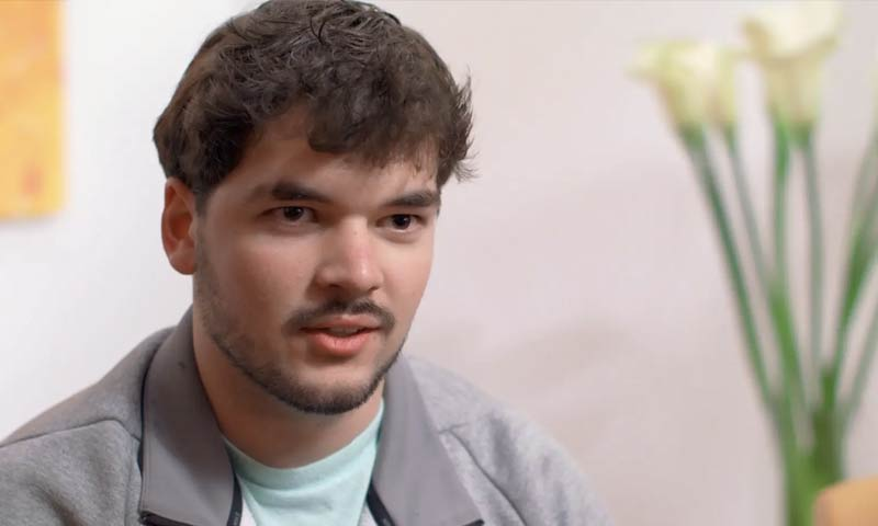 Timothy Muehlhauser looking at the camera and being interviewed.