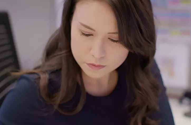 Close up of Elizabeth working in her office.