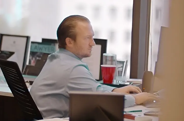 Johnny working at his computer in his office.