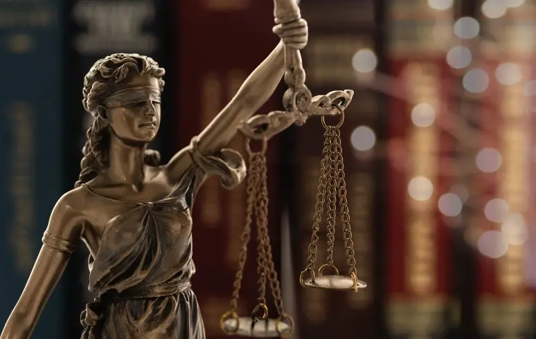 Lady of justice statue with a blurred out background.