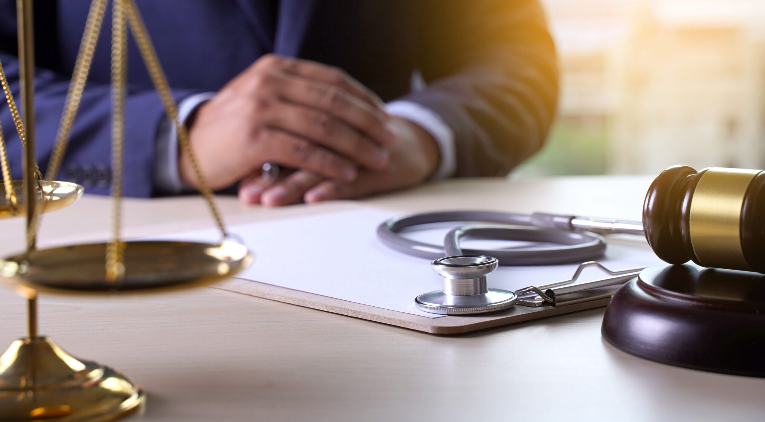 Lawyer sitting at a table discussing a medical negligence case.