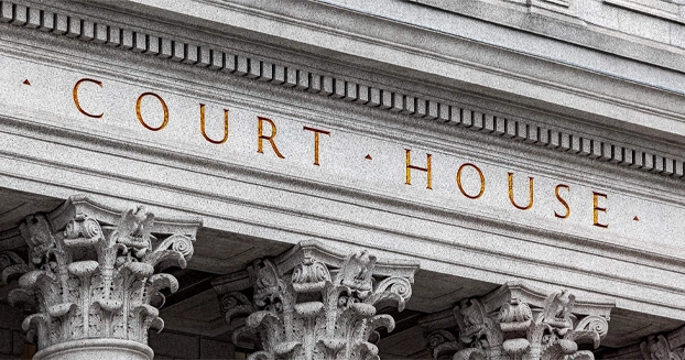 Close up of the words "court house" on a government building with columns.