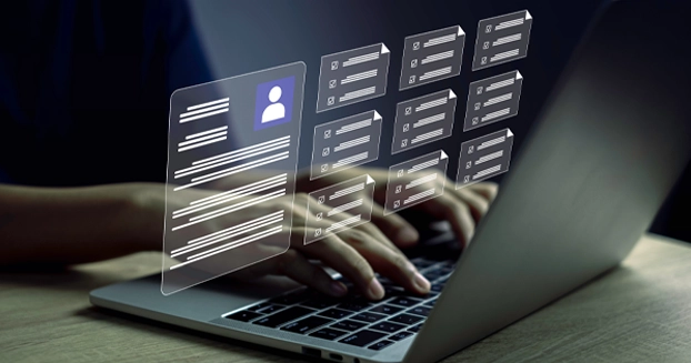 hands typing on a laptop with user profiles screened in front.