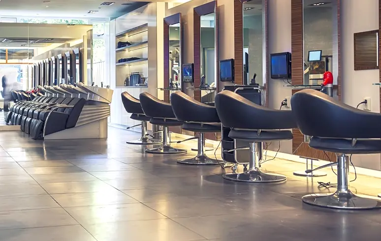 Wide angle of a hair salon with washing stations in the background.