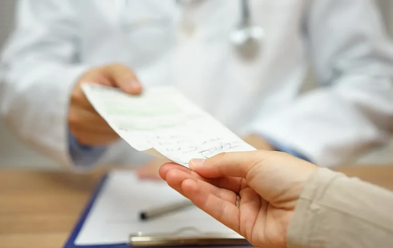 doctor handing prescription