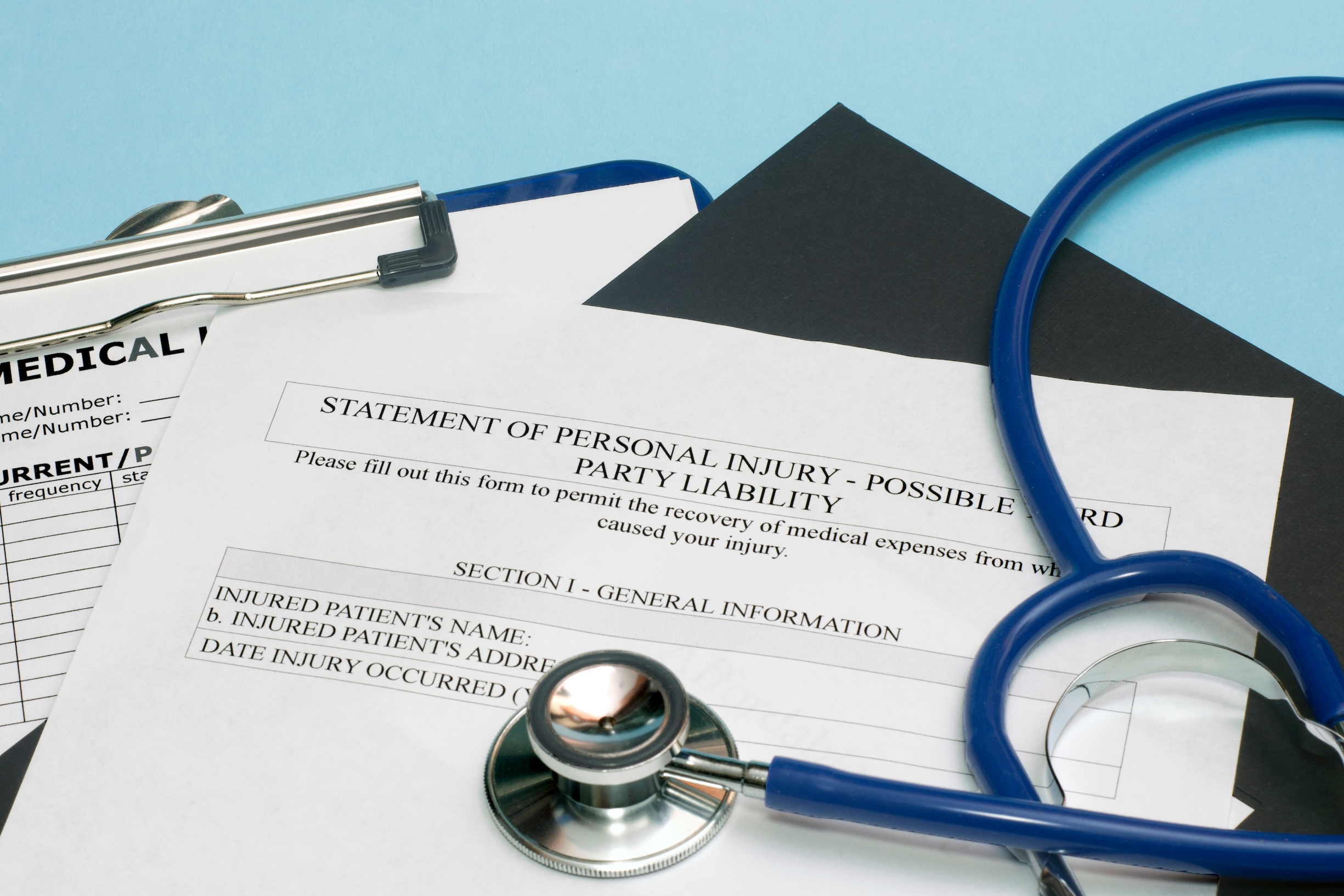 Statement of personal injury form with patient chart and stethoscope.