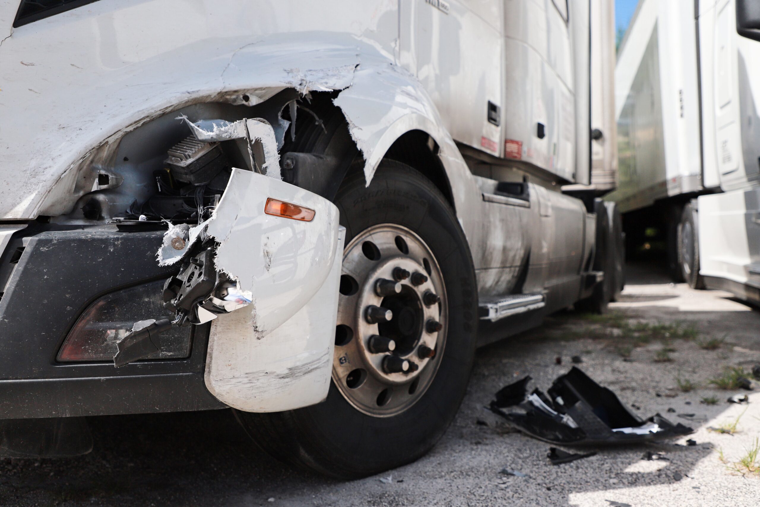 Damage closeup on white truck after an accident.